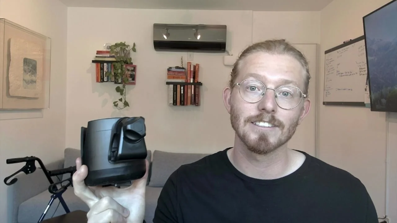 Jace, GoSteady’s founder, holding the cupholder beside a walker